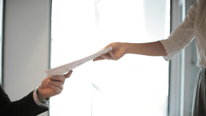 People passing on a document